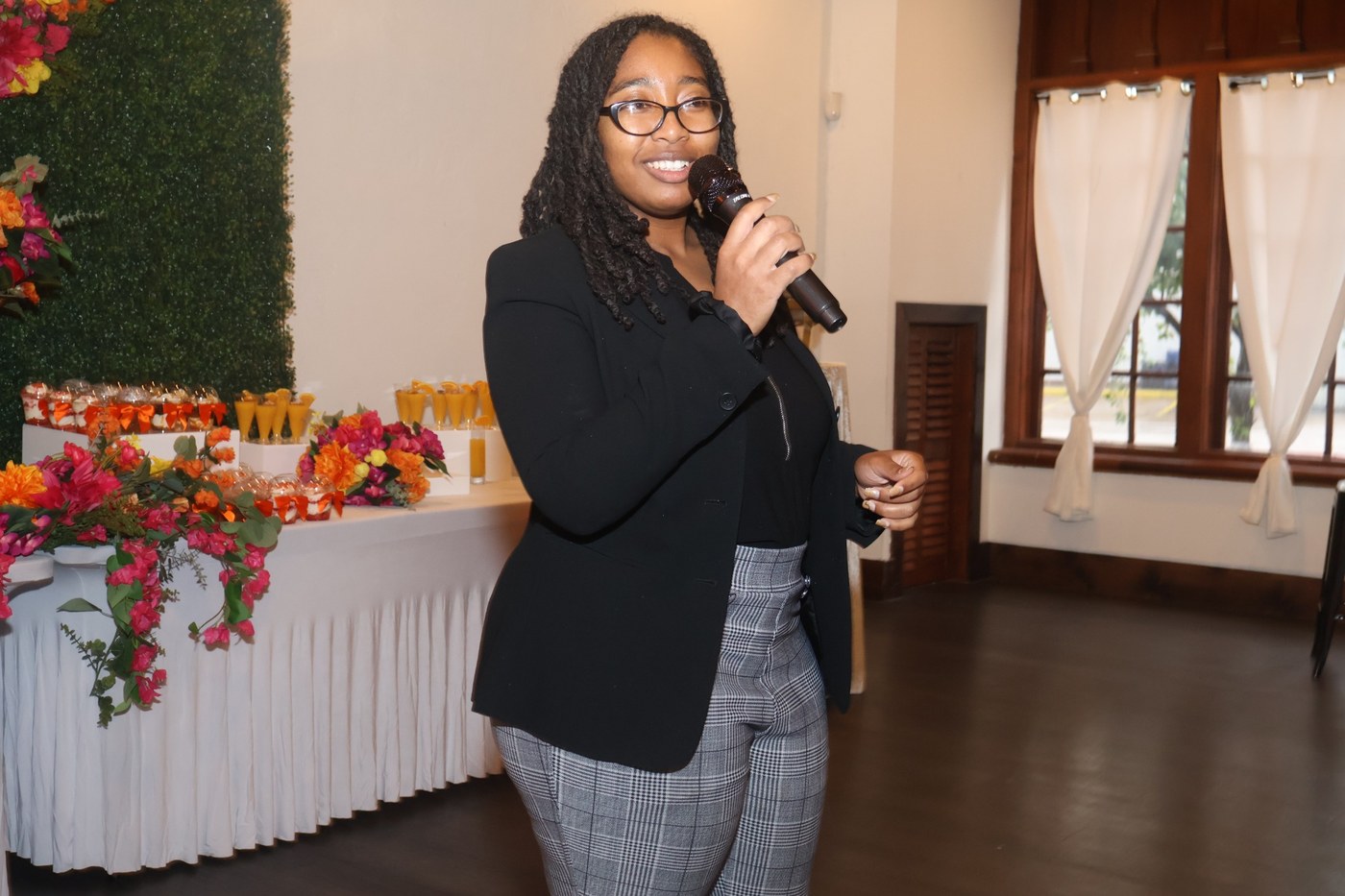 LaCole Purley speaking with a microphone at a community event
